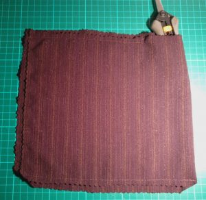 Rectangle of material folded and sewn most of the way around