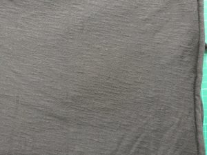 Black T-shirting - with selvage vertical on the right, and grain quite obviously at an angle